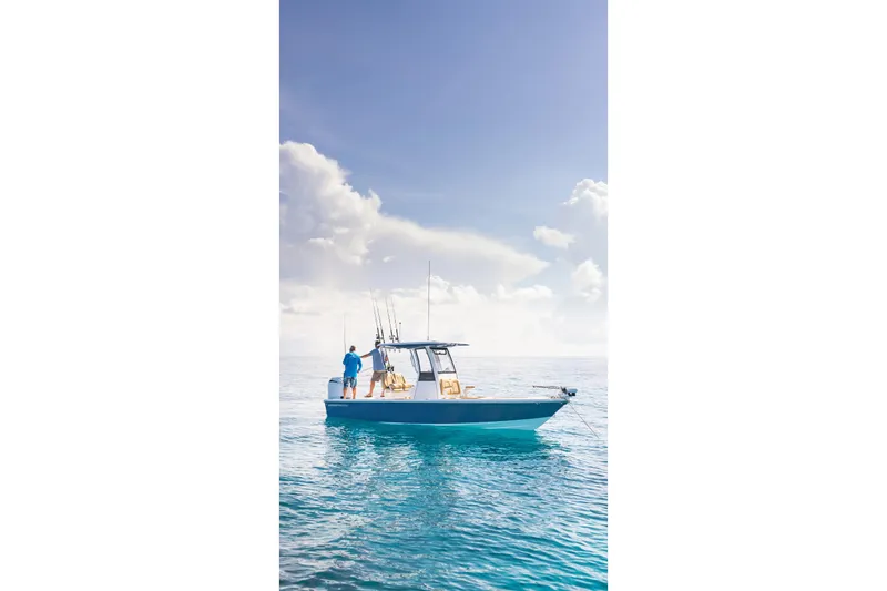 Slide: The Image of 2026 Sportsman Masters 247OE Bay Boat in showroom with Mercury engines. - 2