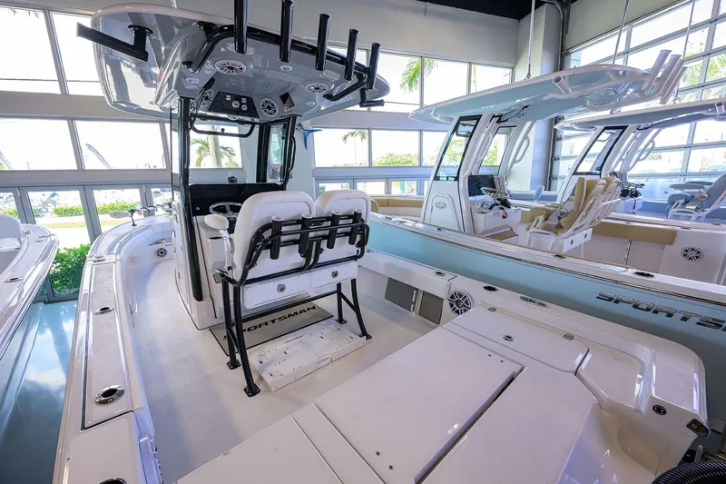 Slide: The Image of 2026 Sportsman Masters 247OE Bay Boat interior in showroom, featuring modern seating and controls. - 20