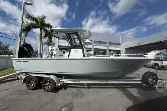 Slide: The Image of 2026 Sportsman Masters 247OE Bay Boat on trailer, parked outdoors under blue sky. - 30