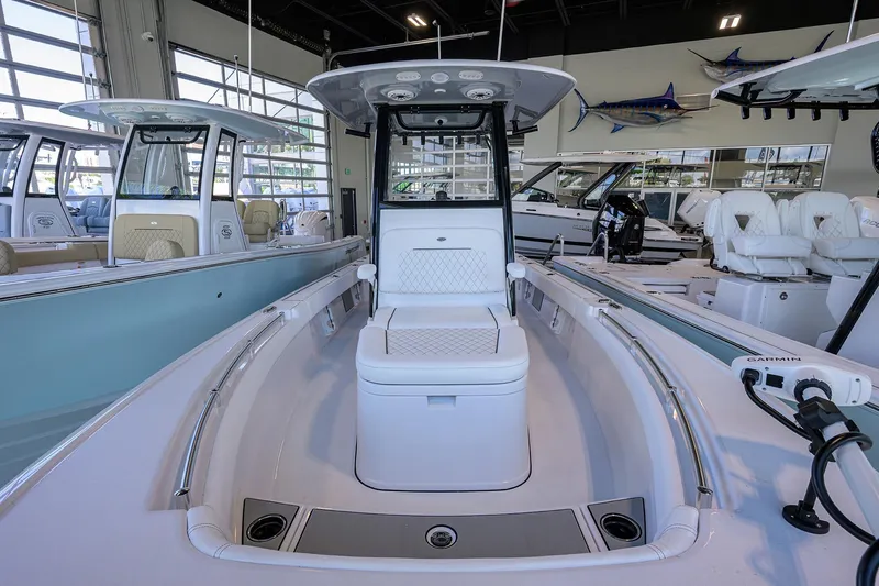 Slide: The Image of 2026 Sportsman Masters 247OE Bay Boat interior in showroom, featuring seating and modern design. - 7