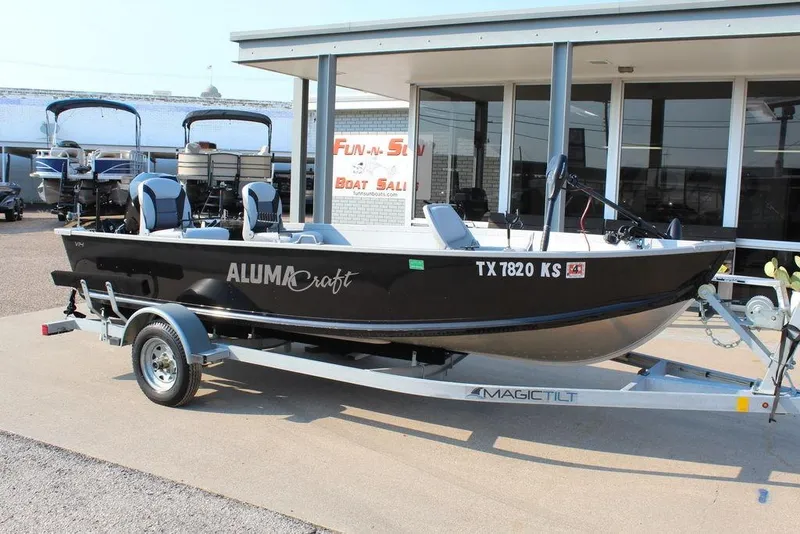 Slide: The Image of 2022 Alumacraft V14 boat on trailer outside dealership. - 1