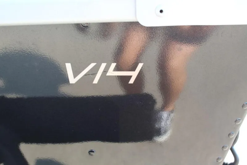 Slide: The Image of Close-up of 2022 Alumacraft V14 boat model lettering on a reflective surface. - 5