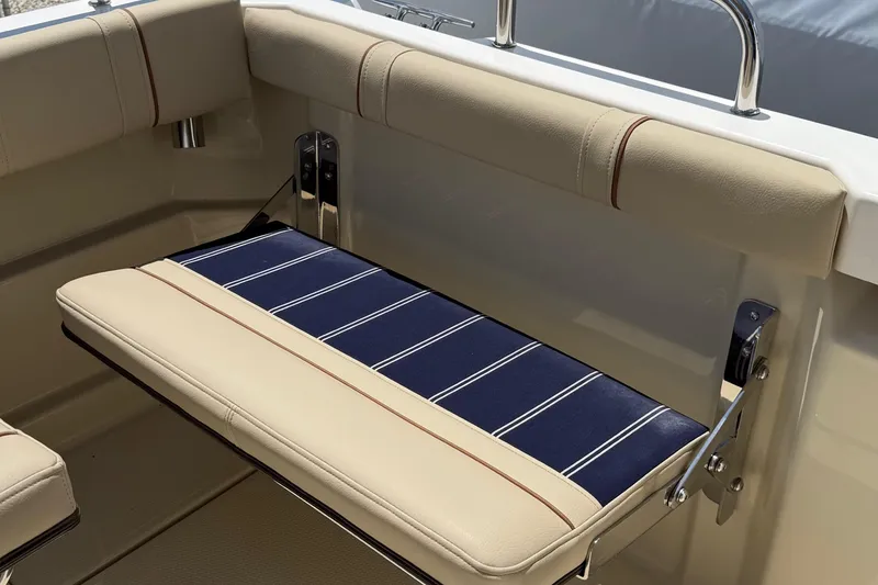 Slide: The Image of 2025 Ranger Tugs R-23 boat seat with beige and blue striped upholstery. - 15