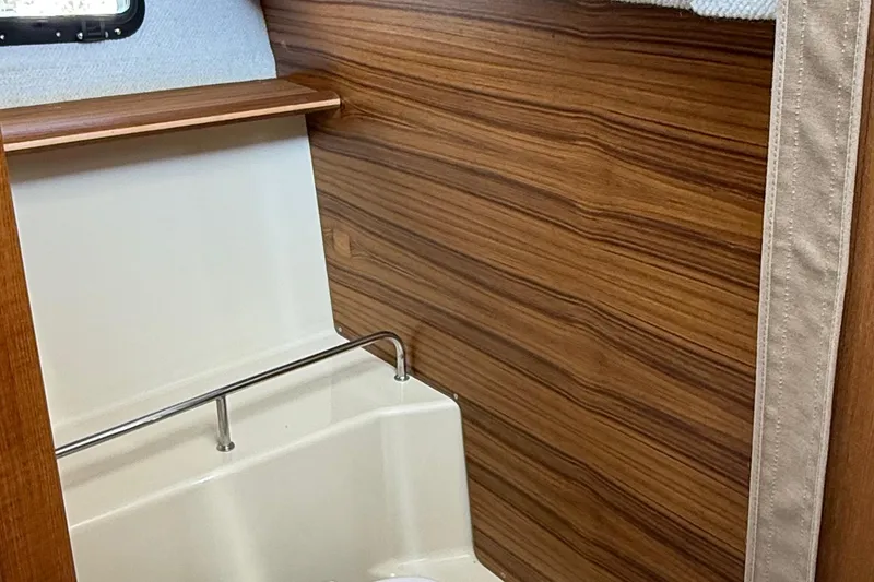 Slide: The Image of Interior of 2025 Ranger Tugs R-23 boat with wood paneling and compact design. - 43