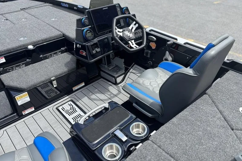Slide: The Image of 2026 Bass Cat Puma STS boat interior with modern dashboard and seating. - 9
