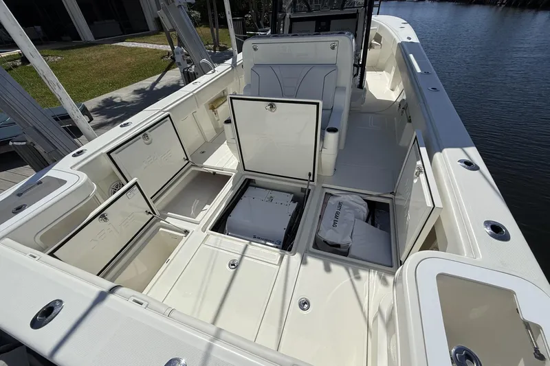 Slide: The Image of 2021 SeaVee 37 boat interior with open storage compartments and seating. - 14