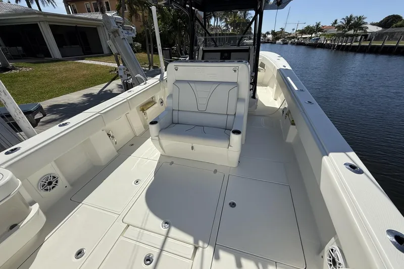 Slide: The Image of 2021 SeaVee 37 boat deck with seating, docked by a canal. - 17