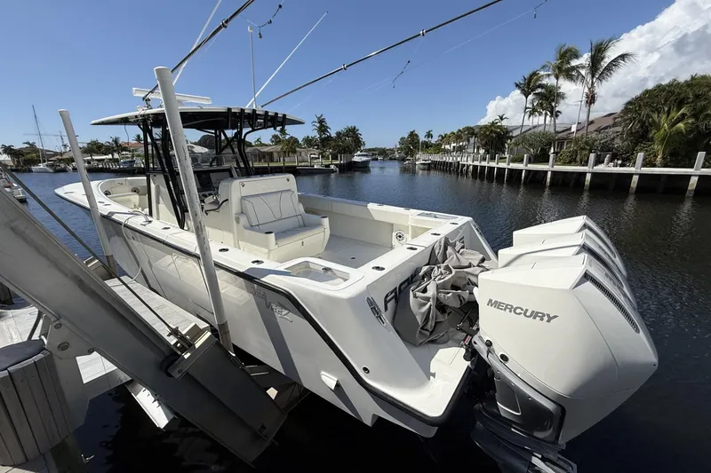 Slide: The Image of 2021 SeaVee 37 boat with triple Mercury engines docked in a scenic canal. - 4