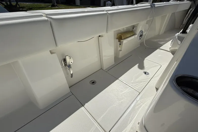 Slide: The Image of 2021 SeaVee 37 boat deck with storage compartments and clean white finish. - 7