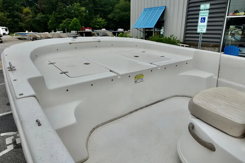Slide: The Image of 2016 Carolina Skiff Standard 2180 boat interior with seating and storage compartments. - 10