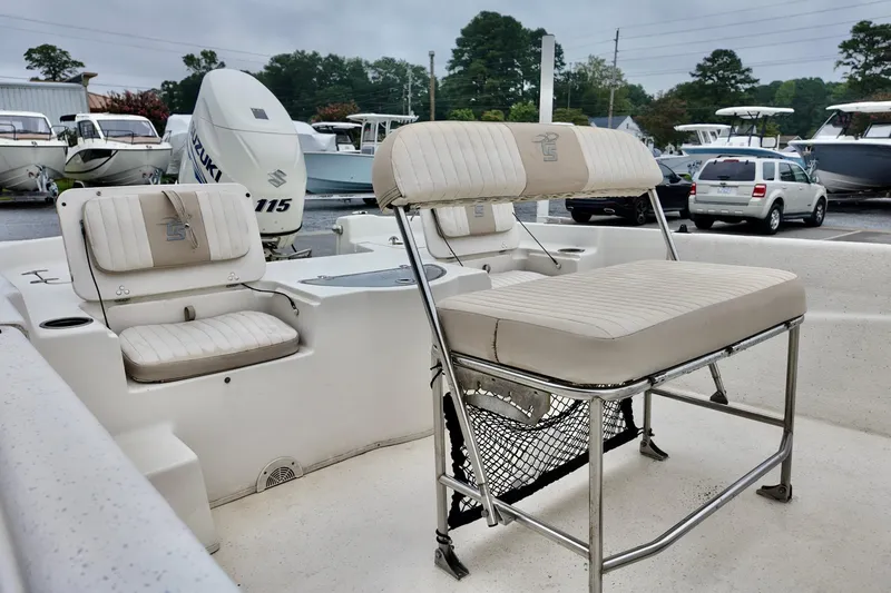 Slide: The Image of 2016 Carolina Skiff Standard 2180 boat interior with seating and Suzuki 115 outboard motor. - 4