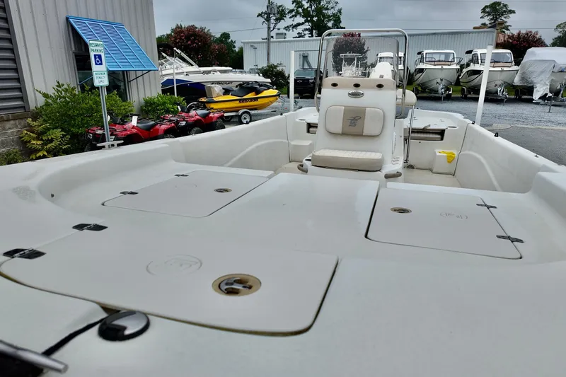Slide: The Image of 2016 Carolina Skiff Standard 2180 boat in a marina with other vessels. - 9