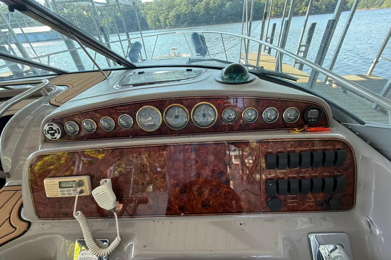 Slide: The Image of Control panel of a 2000 Wellcraft 3300 Martinique boat, docked by the water. - 4