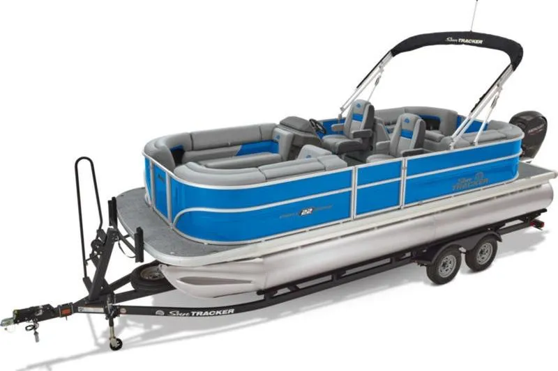 The Image of 2026 Sun Tracker Party Barge 22 DLX pontoon boat on trailer, blue and gray design. - 0