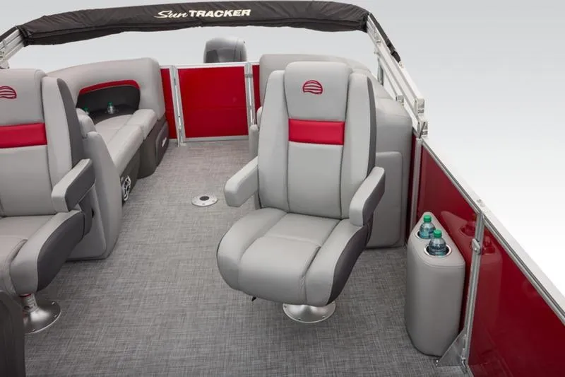 Slide: The Image of 2026 Sun Tracker Party Barge 22 DLX interior with gray and red seating, cup holders. - 28