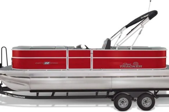 Slide: The Image of 2026 Sun Tracker Party Barge 22 DLX pontoon boat with red and silver design on trailer. - 4