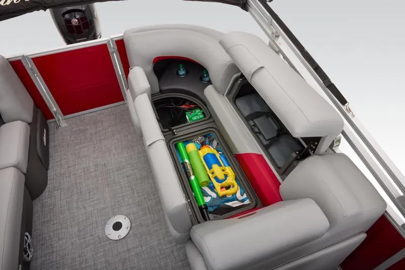 Slide: The Image of 2026 Sun Tracker Party Barge 22 DLX interior with storage compartment open, revealing water toys. - 45