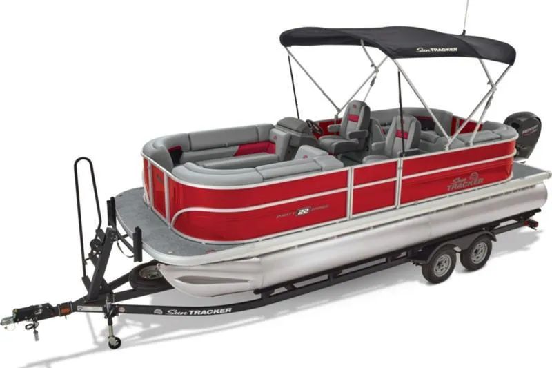 Slide: The Image of 2026 Sun Tracker Party Barge 22 DLX pontoon boat with red and gray seating on a trailer. - 7