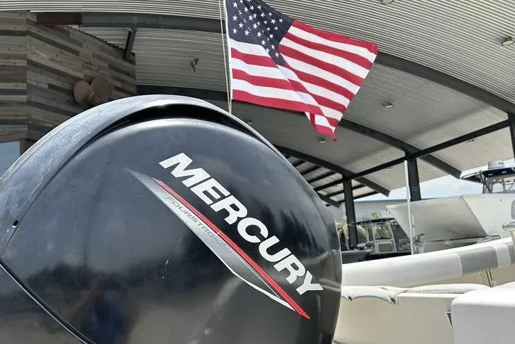 Slide: The Image of Mercury outboard motor on 2020 Mako 214 CC boat with American flag in background. - 4