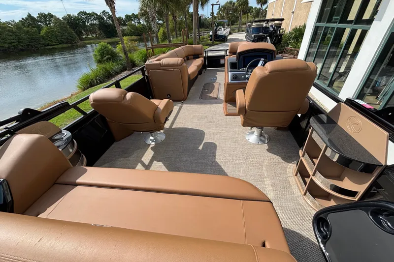 Slide: The Image of Luxurious interior of 2025 Regency 250 LE3 Sport pontoon boat with tan seating. - 9