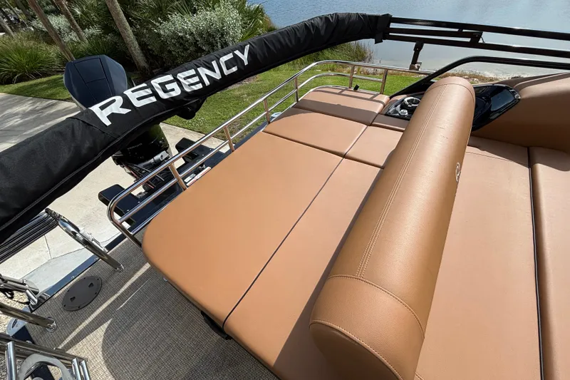 Slide: The Image of 2025 Regency 250 LE3 Sport boat with tan seating and protective cover. - 7