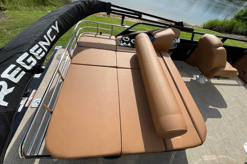 Slide: The Image of Luxurious seating on 2025 Regency 250 LE3 Sport pontoon boat, featuring tan upholstery and sleek design. - 8