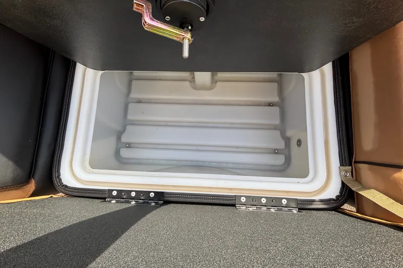 Slide: The Image of 2025 Regency 250 LE3 Sport storage compartment, open and empty, with secure latch mechanism. - 14
