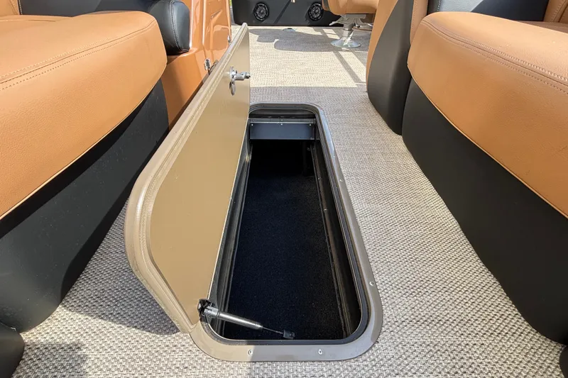 Slide: The Image of Open storage compartment in 2025 Regency 250 LE3 Sport boat interior. - 18