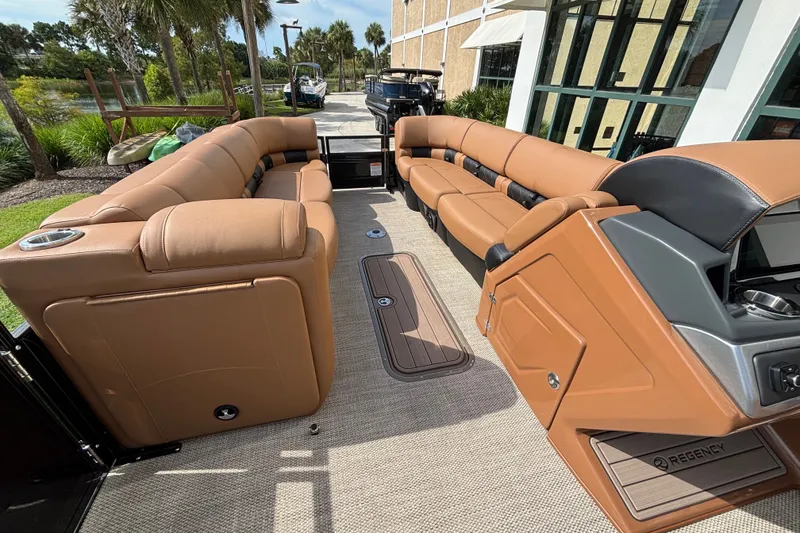 Slide: The Image of Luxurious interior of 2025 Regency 250 LE3 Sport pontoon boat with tan seating and modern design. - 12