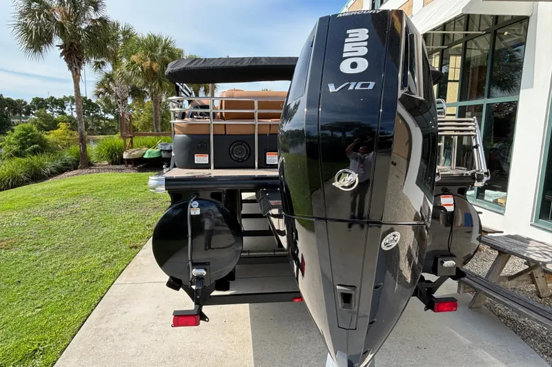 Slide: The Image of 2025 Regency 250 LE3 Sport boat with powerful Mercury 350 V10 engine, parked outdoors. - 4