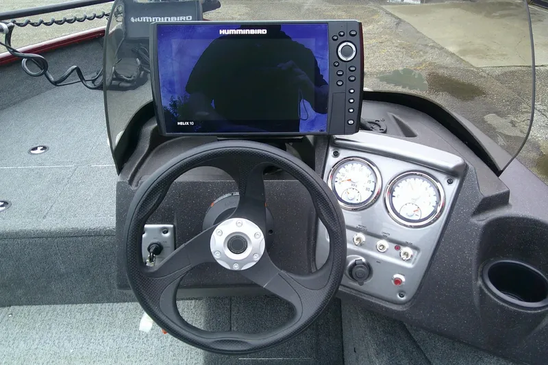 Slide: The Image of 2023 Tracker Pro Guide V-16 SC dashboard with steering wheel and Humminbird Helix 10 display. - 12