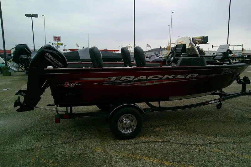 Slide: The Image of 2023 Tracker Pro Guide V-16 SC boat on trailer in parking lot. - 14