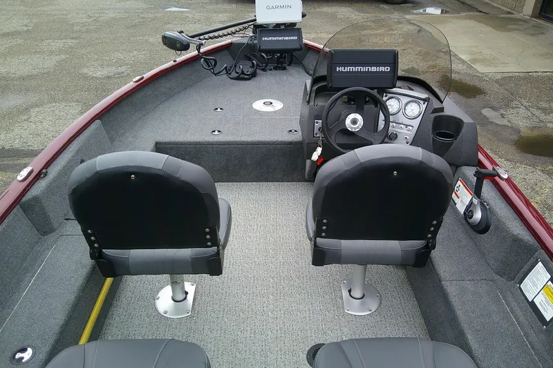 Slide: The Image of 2023 Tracker Pro Guide V-16 SC boat interior with steering console and seating. - 59