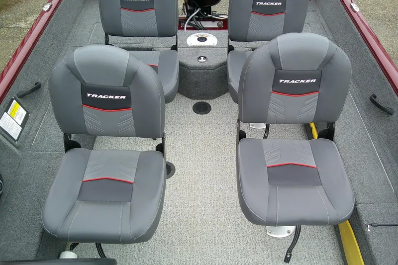 Slide: The Image of 2023 Tracker Pro Guide V-16 SC boat interior with four gray seats. - 6