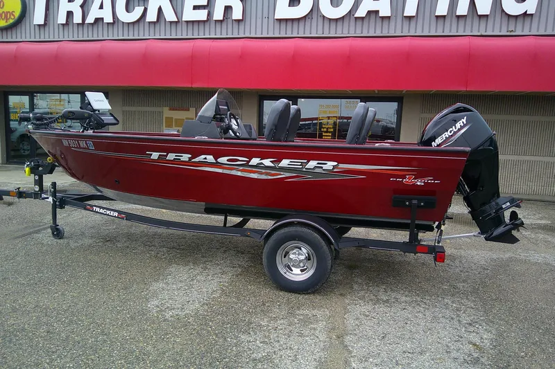 Slide: The Image of 2023 Tracker Pro Guide V-16 SC boat on trailer outside dealership. - 60