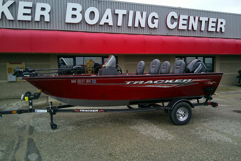 Slide: The Image of 2023 Tracker Pro Guide V-16 SC boat displayed at a boating center. - 62