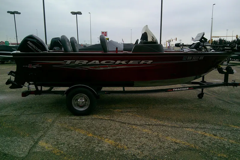 Slide: The Image of 2023 Tracker Pro Guide V-16 SC boat on trailer, parked in outdoor lot. - 64