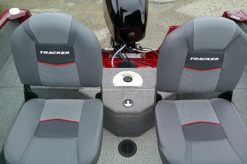 Slide: The Image of 2023 Tracker Pro Guide V-16 SC boat seats with gray upholstery and red accents. - 8