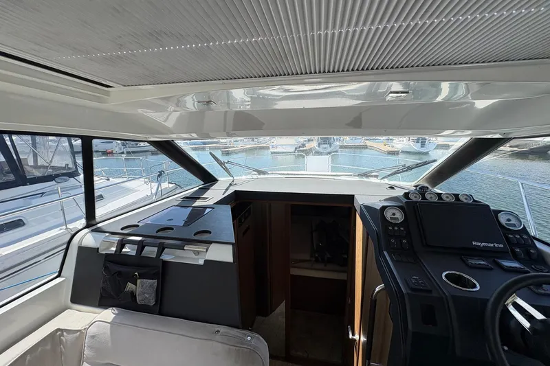Slide: The Image of Interior view of 2019 Jeanneau NC 33 yacht cockpit with navigation equipment. - 10