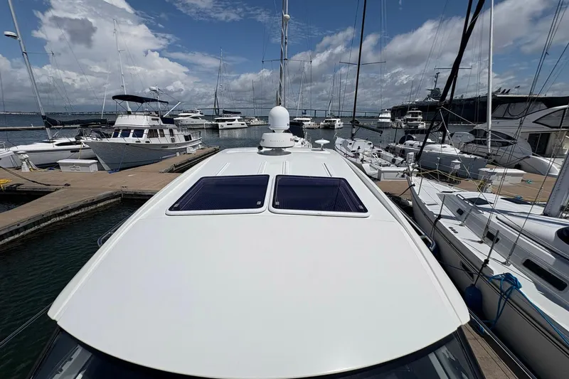 Slide: The Image of 2019 Jeanneau NC 33 yacht docked at a marina, surrounded by other boats. - 22