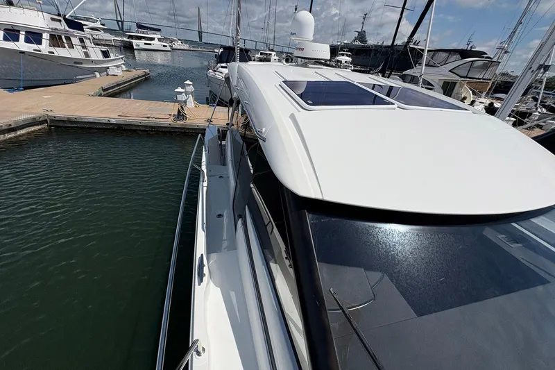 Slide: The Image of 2019 Jeanneau NC 33 docked at marina, showcasing sleek design and modern features. - 23