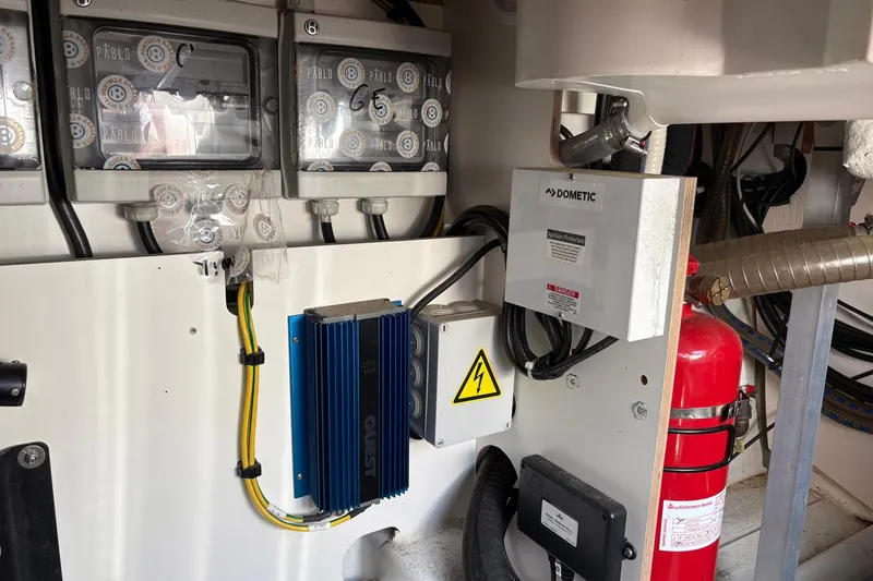 Slide: The Image of Electrical system and fire extinguisher in 2019 Jeanneau NC 33 boat engine room. - 27