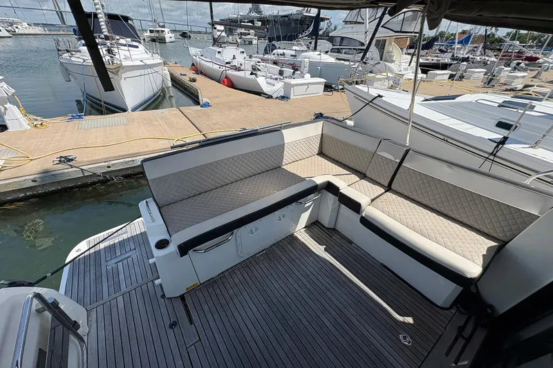 Slide: The Image of 2019 Jeanneau NC 33 yacht with spacious deck seating at marina. - 6