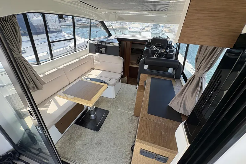 Slide: The Image of Interior of 2019 Jeanneau NC 33 yacht with modern seating and helm station. - 8