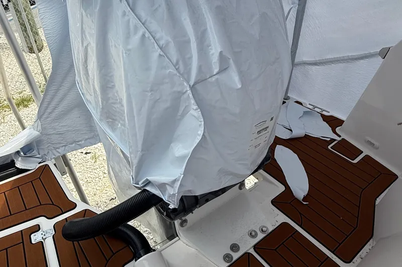 Slide: The Image of 2025 Ranger Tugs R-25 boat deck with covered engine and wooden flooring. - 14