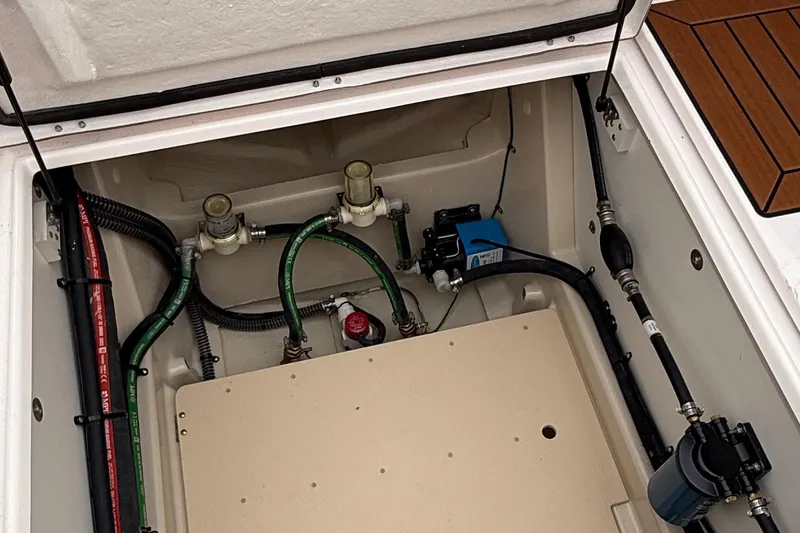 Slide: The Image of Engine compartment of 2025 Ranger Tugs R-25 boat, showcasing hoses and components. - 16