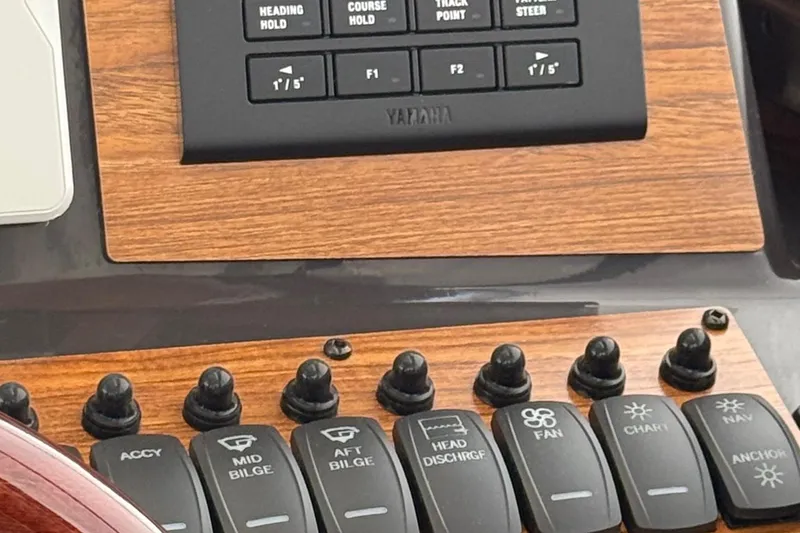 Slide: The Image of Control panel of 2025 Ranger Tugs R-25 boat with various switches and buttons. - 22
