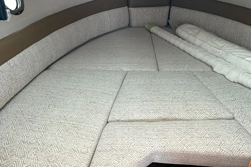 Slide: The Image of 2025 Ranger Tugs R-25 interior cabin with cushioned sleeping area. - 40