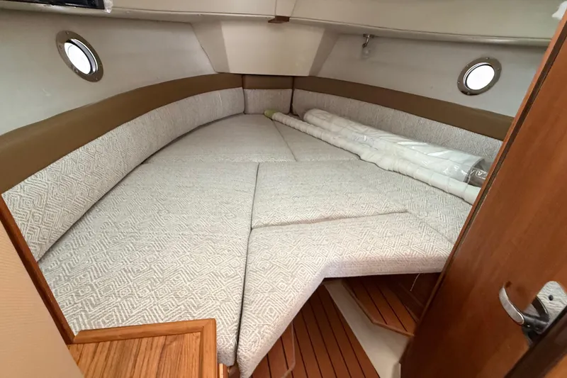 Slide: The Image of Cozy interior cabin of 2025 Ranger Tugs R-25 with comfortable bedding and wooden accents. - 41