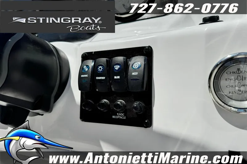Slide: The Image of Control panel of 2026 Stingray 191DC Dual Console boat with switches and gauges. - 14
